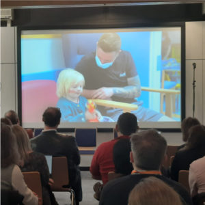 Participants watching a video at the paediatrics oncology workshop