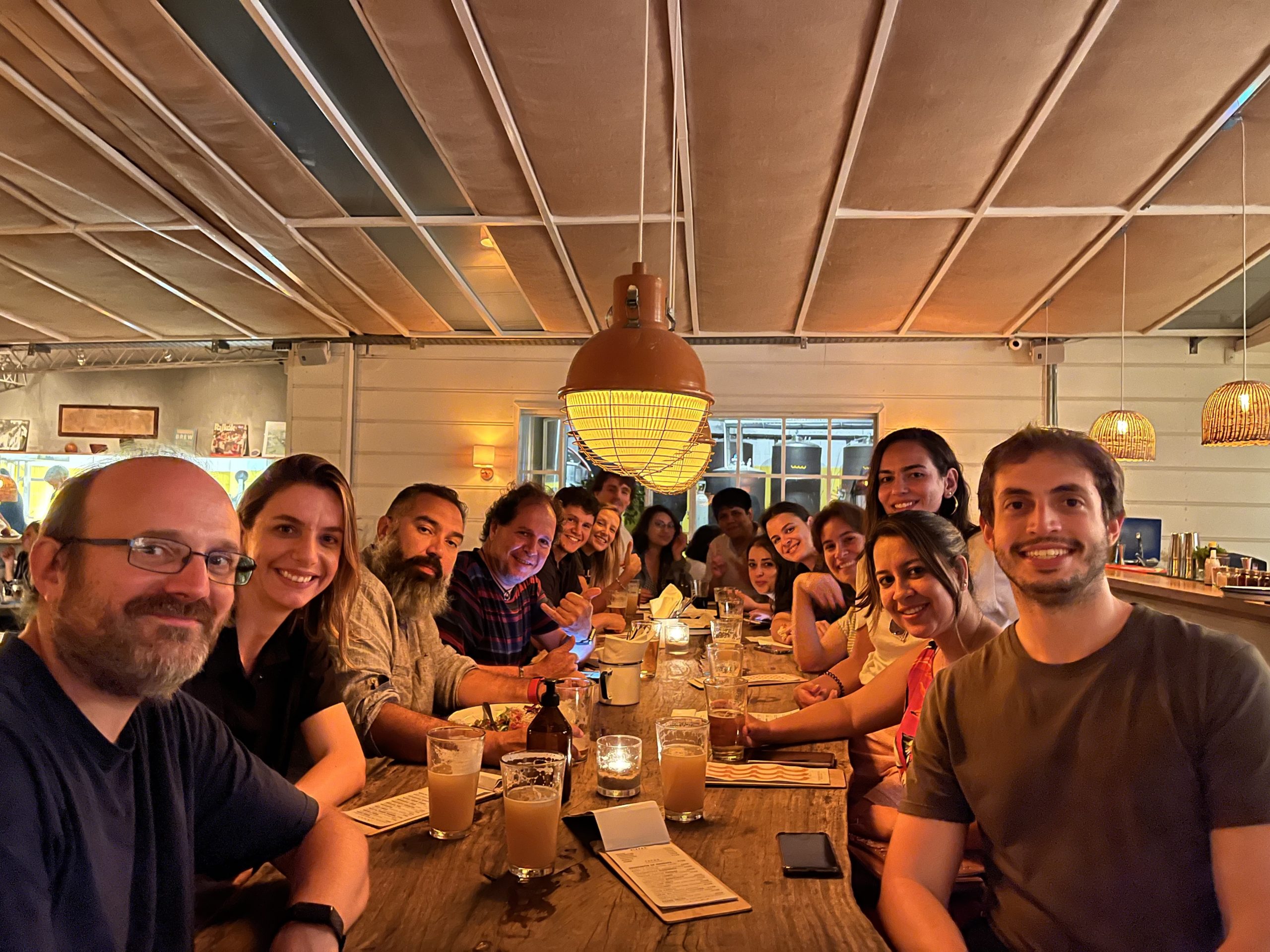 Image shows a group of course participants posing for a photograph during a social dinner