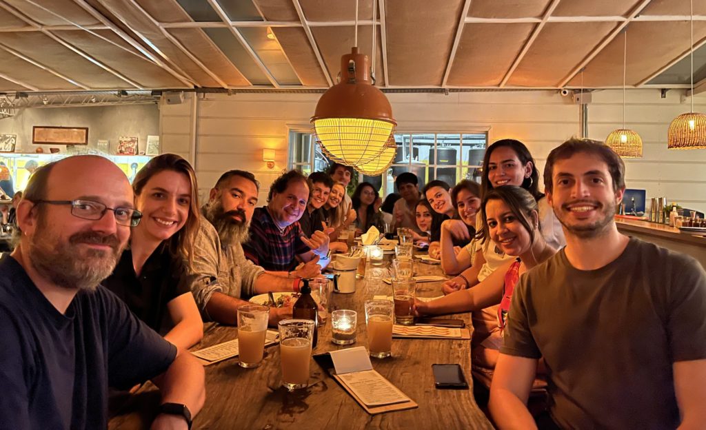 A colour photo of the 2022 Drug Discovery course participants, in Uruguay, socialising during an evening dinner. 