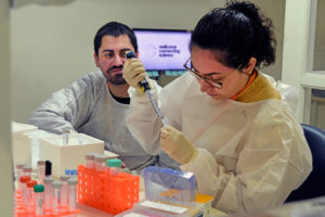 Two course participants from Latin America working in the training lab