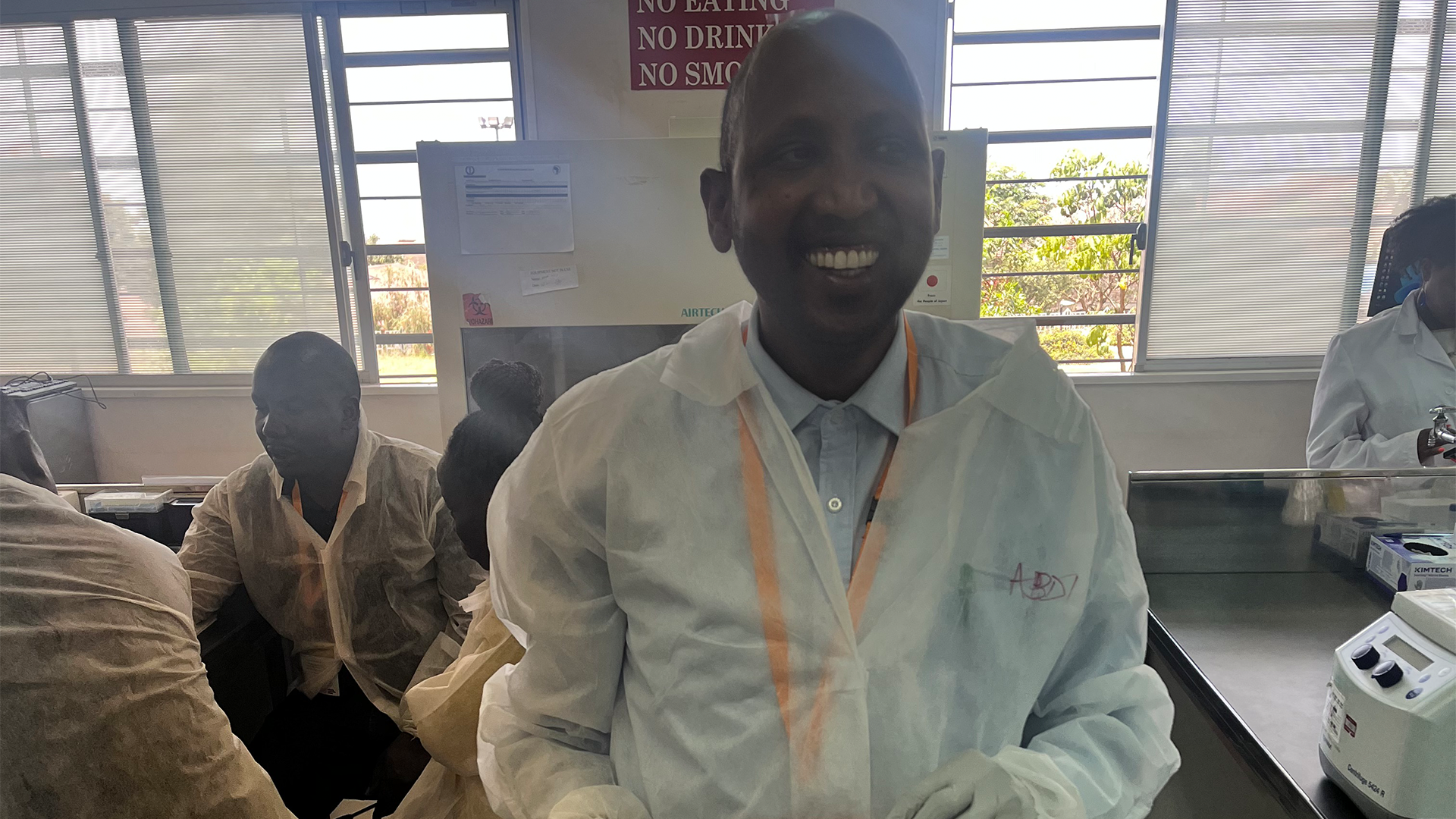 Dr Abdi Mohamed wearing a laboratory coat. 