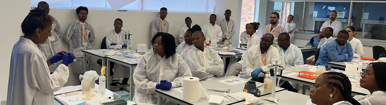 A group of course participants taking part in a training exercise, in a laboratory facility at the National Institute for Communicable diseases