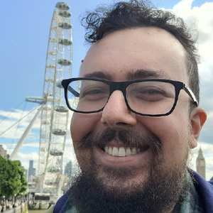 Leonardo Sanches standing on the Southbank with a view of the London Eye in the background. 