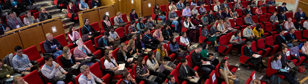 Conference delegates seated in an auditorium