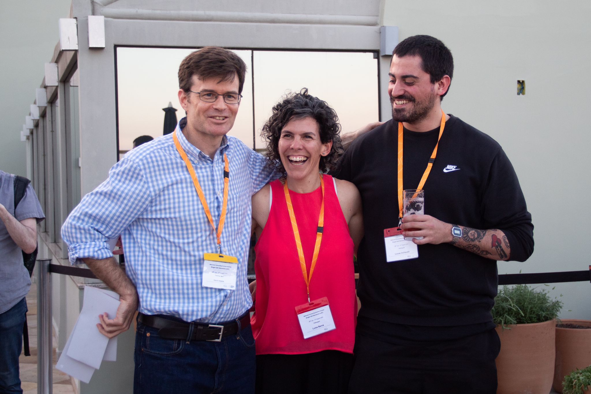 Luisa Berná, Lucas Inchausti Ravela, and David Adams chatting during a social session.