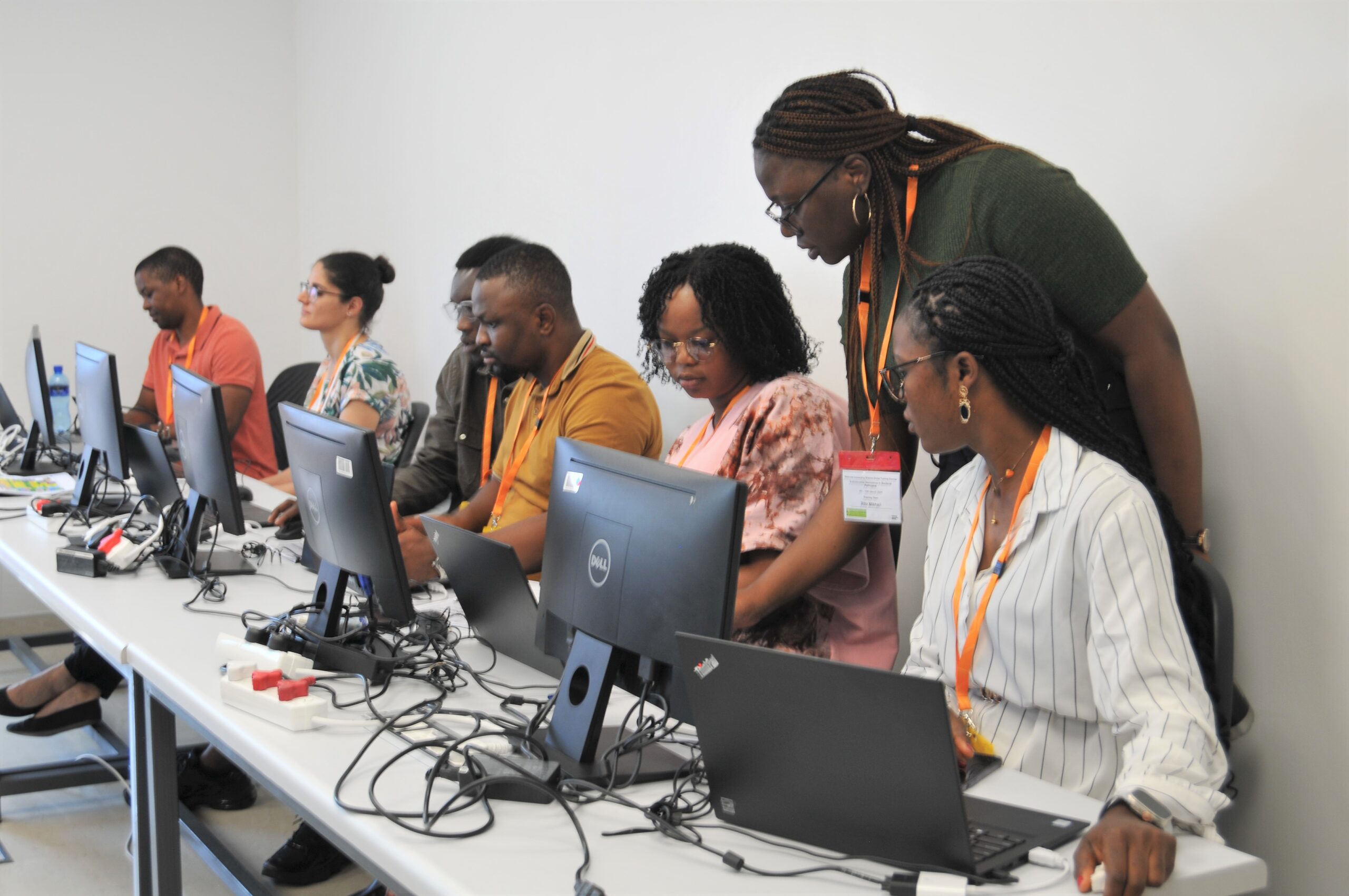 A group of course participants during a computational session, The trainer is teaching them how to interpret genomics data, at our partner training facility at the National Institute of Communicable Diseases (NICD), South Africa