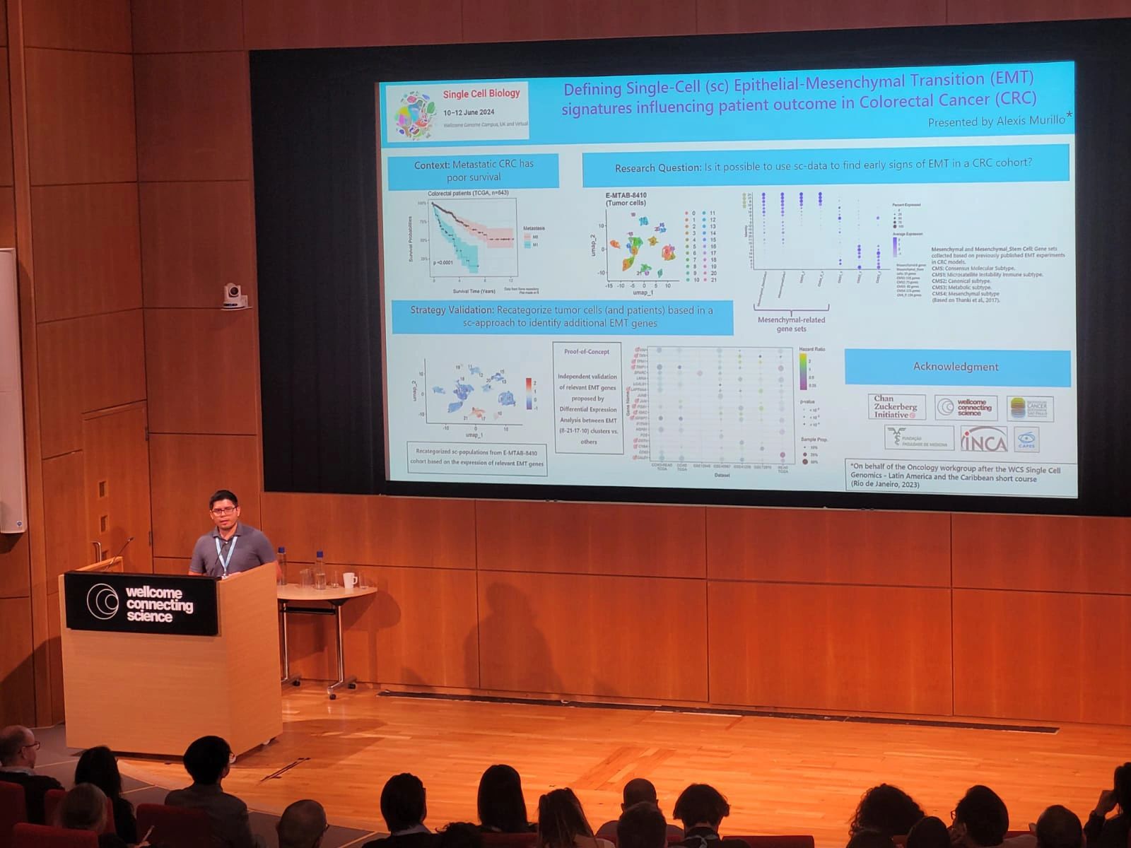 Alexis Murillo Carrasco presenting his research on the auditorium stage, at Hinxton Hall Conference Centre, as part of the Single Cell Biology meeting programme. 