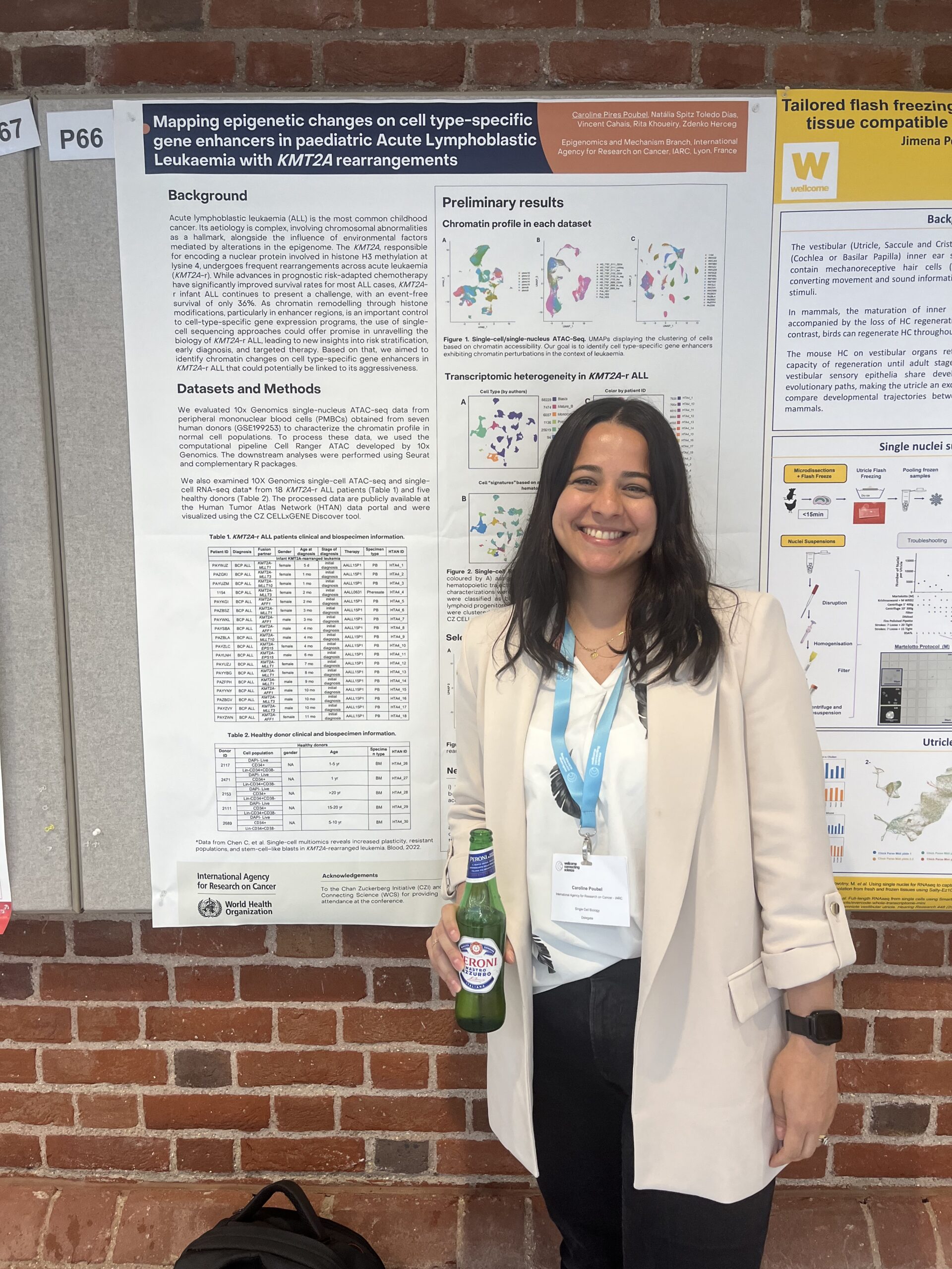 Caroline Poubel stands in front of her poster in the exhibition space at Hinxton Hall Conference Centre. 