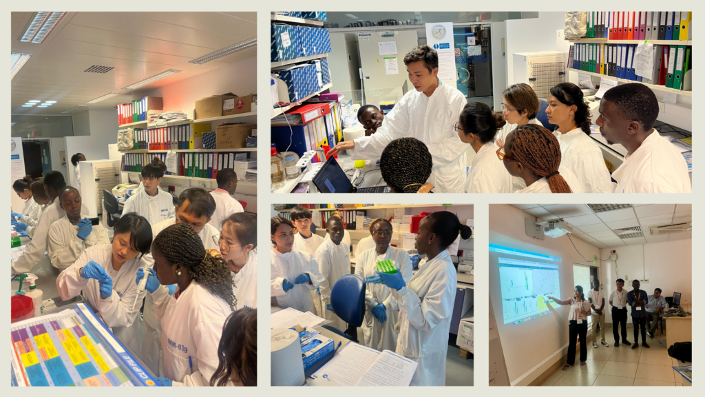 Course participants in the training laboratory at KEMRI-Wellcome working through hands-on DNA extraction exercises. They are all wearing white lab coats and blue safety gloves. 