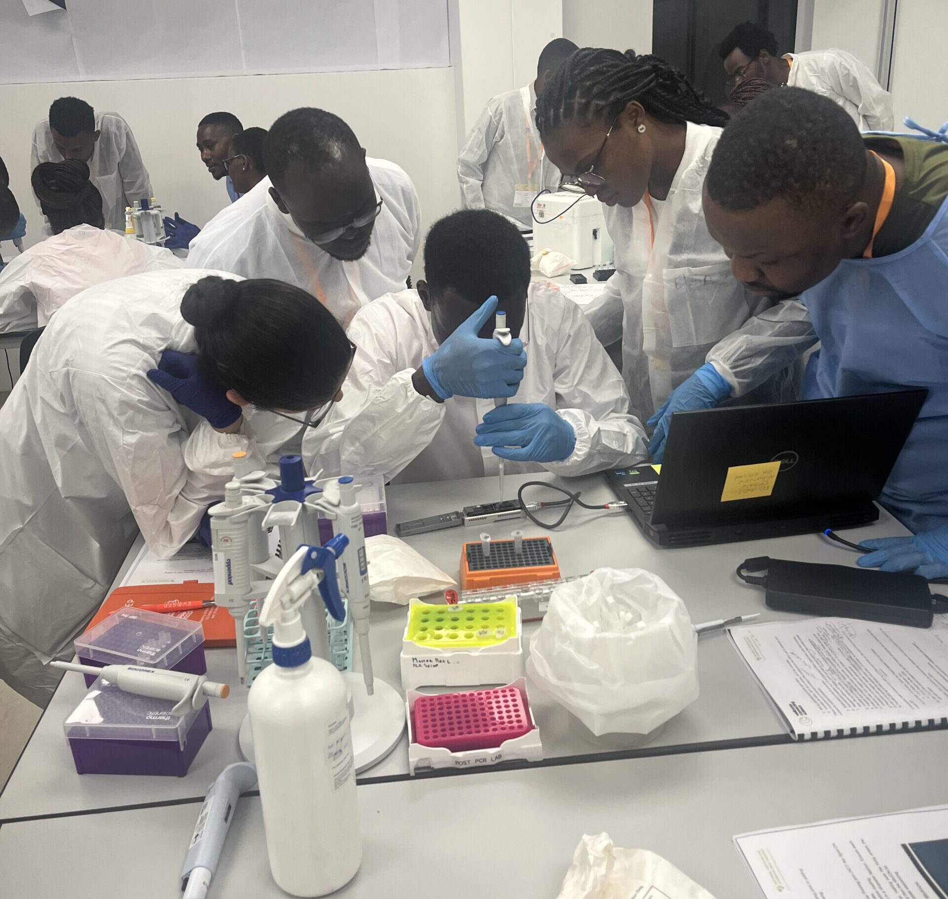 Course participants loading a MinION sequencing machine
