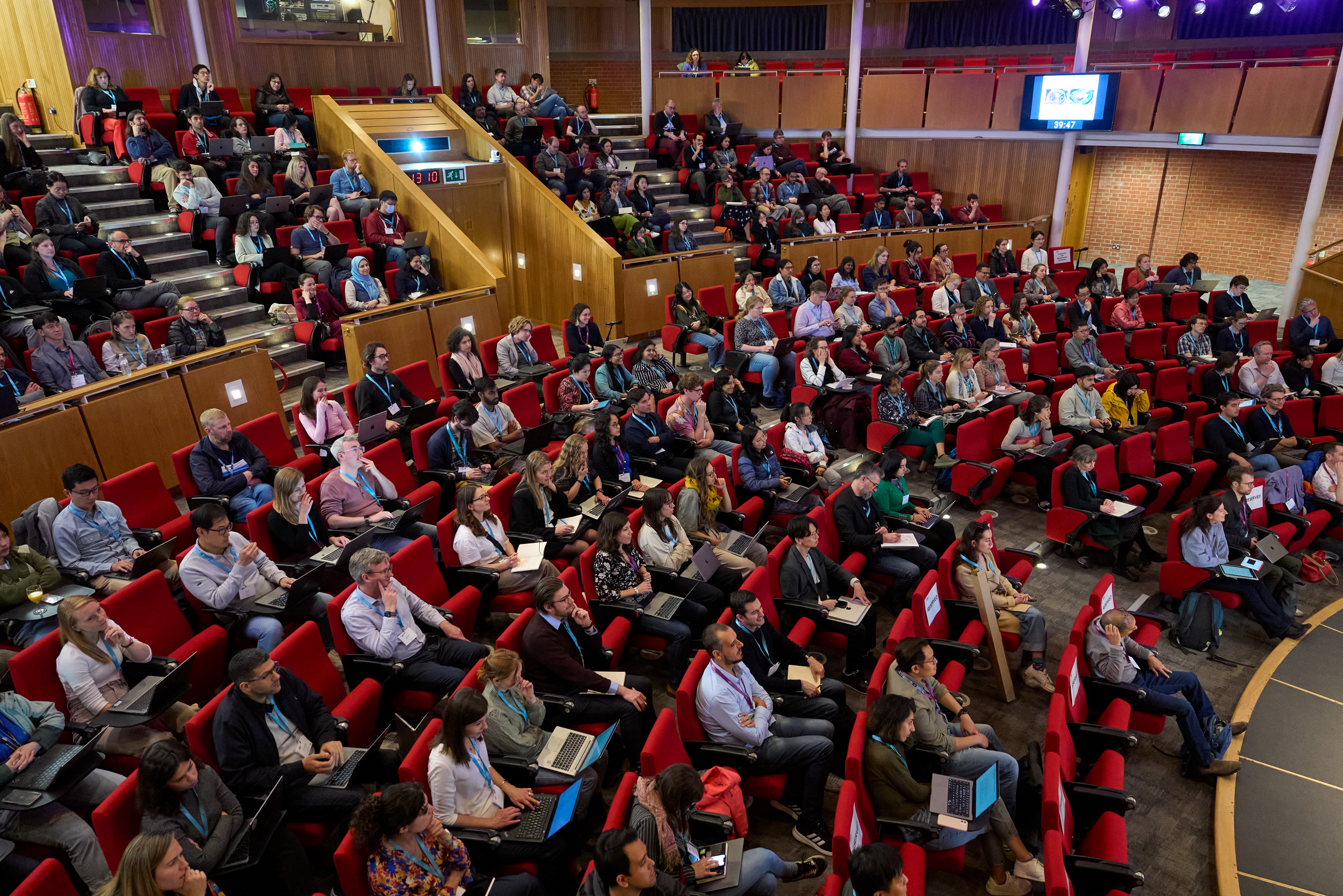 Conference delegates seated in an auditorium.